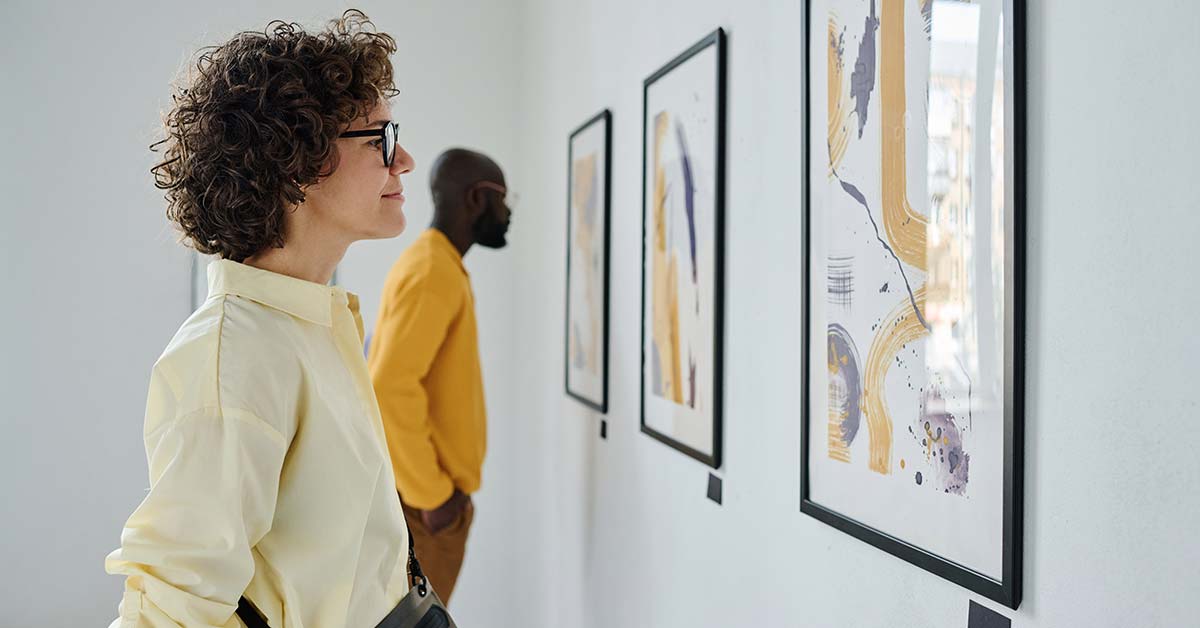 People enjoying their time at an art gallery as they view artwork